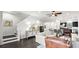 Open-concept living space showing staircase, hardwood floors, comfortable seating, and modern decor at 214 S Audubon Ave, Tampa, FL 33609