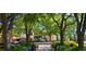 Charming town center with lush landscaping, pedestrian walkways, seating areas, and decorative fountain at 214 S Audubon Ave, Tampa, FL 33609
