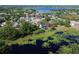 Stunning aerial view of a lakeside home with a private deck, surrounded by lush greenery at 219 Galaxy Ave, Spring Hill, FL 34606