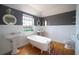 Charming bathroom with clawfoot tub, pedestal sinks, and decorative mirrors for a vintage feel at 219 Galaxy Ave, Spring Hill, FL 34606