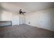 Spacious room with beige carpet flooring and a ceiling fan, offering versatility and comfort at 219 Galaxy Ave, Spring Hill, FL 34606