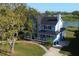 Charming two-story home with a welcoming front porch and a well-manicured lawn at 219 Galaxy Ave, Spring Hill, FL 34606