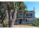 Charming two-story home with a front porch, mature trees, and well-maintained landscaping at 219 Galaxy Ave, Spring Hill, FL 34606