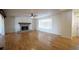 Spacious living room with hardwood floors, a brick fireplace, and large windows at 219 Galaxy Ave, Spring Hill, FL 34606