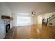 Inviting living room with a brick fireplace, hardwood floors, and a staircase at 219 Galaxy Ave, Spring Hill, FL 34606