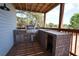 Outdoor kitchen features a built-in grill, sink, and ample counter space for entertaining at 219 Galaxy Ave, Spring Hill, FL 34606