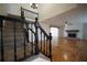 Elegant staircase leading to an open-concept living space with hardwood floors and a fireplace at 219 Galaxy Ave, Spring Hill, FL 34606