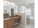 Bathroom features a granite vanity, shower, soaking tub, and frosted glass shower doors at 2203 Malaga Ave, Spring Hill, FL 34609