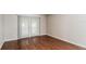 Bright bedroom with hardwood floors and sliding doors leading to outdoor space at 2203 Malaga Ave, Spring Hill, FL 34609