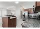 Spacious kitchen with granite countertops, stainless steel appliances, and an island with a sink at 2203 Malaga Ave, Spring Hill, FL 34609