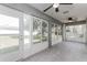 Bright sunroom with tile floors, ceiling fans, and large windows overlooking the backyard at 2203 Malaga Ave, Spring Hill, FL 34609