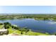 Aerial view of the community lake featuring boat dock, storage racks, and ample tree coverage at 2284 Philippine Dr # 7, Clearwater, FL 33763