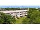 Condominium building's rear exterior with patios, gardens, and mature trees at 2284 Philippine Dr # 7, Clearwater, FL 33763