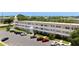Condominium building with a parking lot, maintained landscaping, and secure exterior staircase at 2284 Philippine Dr # 7, Clearwater, FL 33763