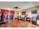 Open living room featuring wood floors, neutral paint, a ceiling fan, and comfortable seating at 2284 Philippine Dr # 7, Clearwater, FL 33763