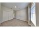 A neutral-colored room featuring plush carpet, bright walls, large window, and a large closet at 2416 Caraway Dr, Venice, FL 34292
