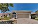 Charming single-story home featuring a two-car garage, well-manicured landscaping, and a welcoming entrance at 2416 Caraway Dr, Venice, FL 34292