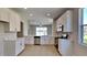 Stylish kitchen with white cabinetry, stainless steel appliances, tile floors, and a view of the living area at 2416 Caraway Dr, Venice, FL 34292