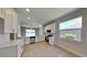 Modern kitchen with white cabinets, stainless steel appliances, tile floors, and a window overlooking the backyard at 2416 Caraway Dr, Venice, FL 34292