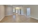 Spacious living room with tile flooring, neutral walls, a chandelier, and a doorway to other rooms at 2416 Caraway Dr, Venice, FL 34292