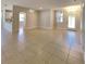 Bright, open-concept living room with neutral paint, tile flooring, and natural light at 2416 Caraway Dr, Venice, FL 34292