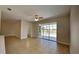 Bright, open living room with tile flooring and sliding doors leading to the screened-in pool area at 2416 Caraway Dr, Venice, FL 34292