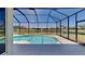 Relaxing screened-in pool overlooking a serene pond and beautiful landscaping at 2416 Caraway Dr, Venice, FL 34292