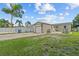 Backyard view with a detached garage, blue skies and lush landscape at 2435 37Th N Ave, St Petersburg, FL 33713