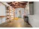 Unfinished basement with wooden beams and shelving, offering ample storage and potential for customization at 2435 37Th N Ave, St Petersburg, FL 33713