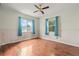 Spacious bedroom with hardwood floors, two windows and decorative blue curtains at 2435 37Th N Ave, St Petersburg, FL 33713