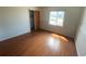 Bright bedroom features hardwood floors, a window with natural light, and a closet at 2435 37Th N Ave, St Petersburg, FL 33713
