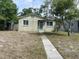 Charming single-story home with a walkway leading to the front door and windows on either side at 2435 37Th N Ave, St Petersburg, FL 33713