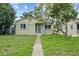 Charming one-story home with a green lawn and mature tree in a residential neighborhood at 2435 37Th N Ave, St Petersburg, FL 33713