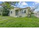 Charming single-story home featuring a cozy front porch and a well-maintained lawn and landscaped yard at 2435 37Th N Ave, St Petersburg, FL 33713