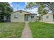 Inviting single-story home featuring a cozy front porch and a well-maintained lawn at 2435 37Th N Ave, St Petersburg, FL 33713