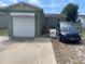 Exterior view of garage with an Overhead Door and a blue van parked alongside the driveway at 2435 37Th N Ave, St Petersburg, FL 33713