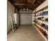 Spacious garage with roll-up door, exposed rafters, and ample shelving for storage at 2435 37Th N Ave, St Petersburg, FL 33713