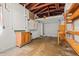 Unfinished garage with wooden beams and shelving, offering ample storage and potential for customization at 2435 37Th N Ave, St Petersburg, FL 33713