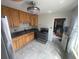 Functional kitchen equipped with appliances, wooden cabinetry, and tiled flooring at 2435 37Th N Ave, St Petersburg, FL 33713
