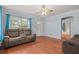 Cozy living room with hardwood floors, blue curtains, and ample natural light from windows at 2435 37Th N Ave, St Petersburg, FL 33713