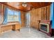 Office space with wood paneling, tiled floors, a decorative fireplace, desk and bright natural light at 2435 37Th N Ave, St Petersburg, FL 33713