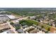 An aerial view of a neighborhood with retail centers in the distance at 2530 Sandy Beach Ln, Clearwater, FL 33763