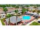Aerial view showcasing a community pool, playground, and neatly arranged homes, providing a vibrant neighborhood setting at 2530 Sandy Beach Ln, Clearwater, FL 33763