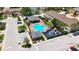 Aerial view of a community featuring a pool, playground, parking, and well-maintained landscaping among residential buildings at 2530 Sandy Beach Ln, Clearwater, FL 33763