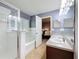 Well-lit bathroom featuring a large tub and walk-in shower at 2530 Sandy Beach Ln, Clearwater, FL 33763