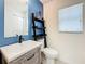 Powder bath with a floating vanity and a wood-like ladder shelf at 2530 Sandy Beach Ln, Clearwater, FL 33763