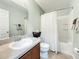 Well-lit bathroom featuring a shower-tub combo and neutral-toned walls at 2530 Sandy Beach Ln, Clearwater, FL 33763