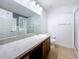Bright bathroom with a large mirror and walk-in shower at 2530 Sandy Beach Ln, Clearwater, FL 33763