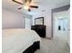 Neutral bedroom with ceiling fan, a dresser and entryways at 2530 Sandy Beach Ln, Clearwater, FL 33763