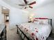 Bright bedroom features an iron bed frame and closet space at 2530 Sandy Beach Ln, Clearwater, FL 33763